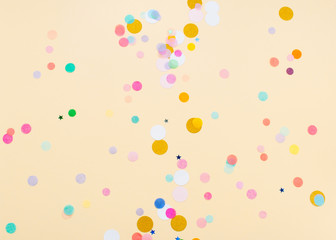 Colored confetti on yellow background