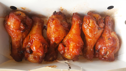 Chicken wings in barbecue sauce in delivery box.