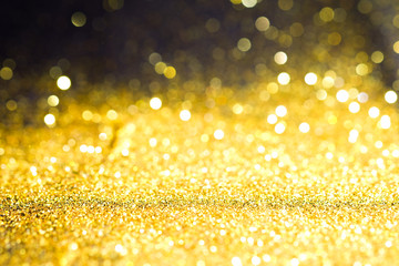 Abstract Sprinkle glitter gold dust on black background textured ,elegant and luxury concept