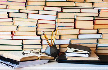 Books background, glasses and notebook on white wooden table
