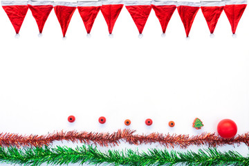 Christmas background with red hat, ball and colorful ribbons