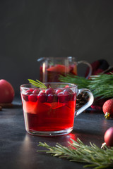 Christmas cranberry and apple mulled wine garnish rosemary and fir branches on black. Xmas drink.