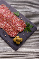 Saucisson sec delicious french salami on a wooden background