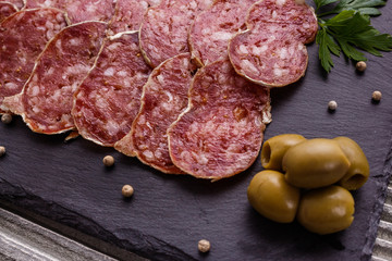 Saucisson sec delicious french salami on a wooden background