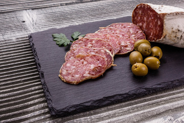 Saucisson sec delicious french salami on a wooden background