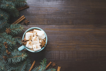 Christmas mug of hot coffee with marshmallow on wooden board. New Year. Holiday card. Rustic style. Top view and copy space.