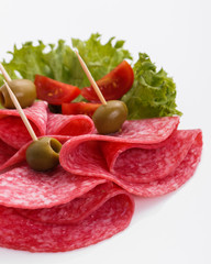 delicious sliced salami on a white background