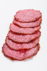 delicious sliced salami on a white background