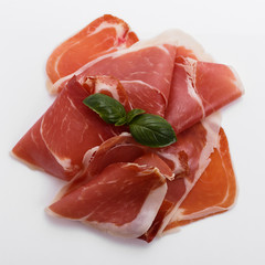 Italian prosciutto crudo or spanish jamon on a white background