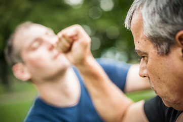 Kapap instructor demonstrates street fighting self defense techniques. Martial arts