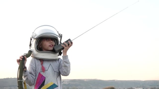 Little Girl with the astronaut helmet in the field