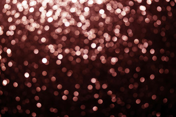 Blurred Christmas background with shiny Living Coral stars