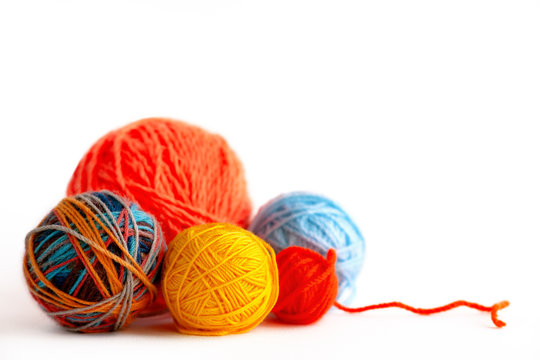 Balls of yarn for knitting on a white background. Macro. Multi-colored yarn for knitting on an isolated white background. Needlework in the form of knitting.
