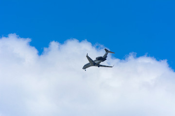 A large passenger airliner is a plane with a big wingspan high in the sky. Transport tourists for exotic holidays against the blue sky and white clouds