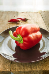 Delicious bell pepper with a pair of chili pepers near it