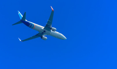 A large passenger airliner is a plane with a big wingspan high in the sky. Transport tourists for...