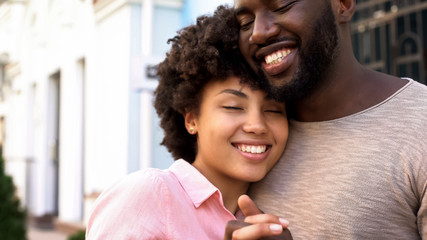 Loving girlfriend hugging boyfriend outdoors, tender relations, love closeness