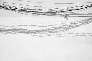shadow on white wall with wire
