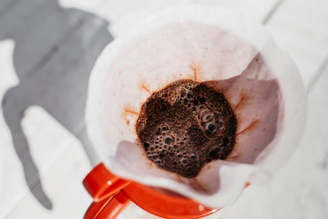 Delicious freshly ground morning coffee powder in the coffee filter