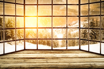Winter window of wood and landscape of mountains and sunset time 