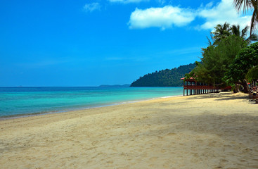 Sandy beach and rocky cape in South China Sea, Pulau Tioman, Malaysia.
