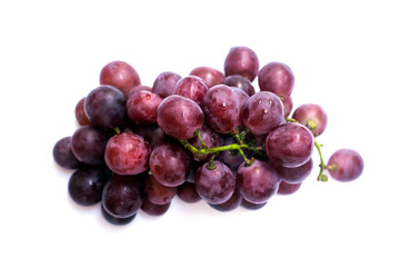 Bunch of purple grapes on a white backdrop.