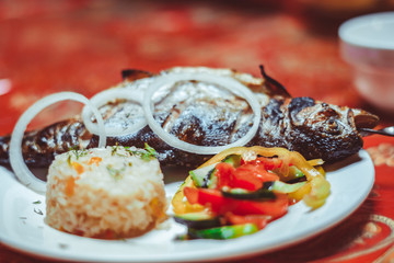 Delicious Asian fish fried on skewers