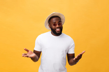 Portrait of handsome young african guy smiling in white t-shirt on yellow background