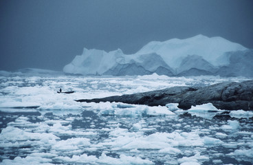 West-Greenland. aAsmall boat between the icebergs