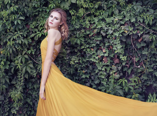 Beautiful woman in golden dress