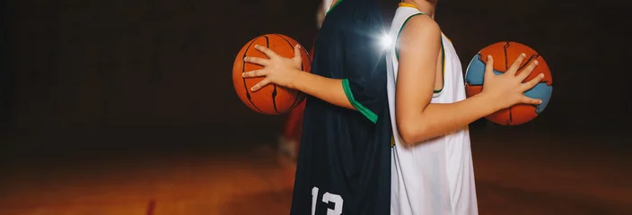  Two Boys Basketball Team Players Holding Basketballs on the Wooden Court. Basketball Training For Kids. Horizontal Background of Youth Basketball Players, Copy Space © matimix