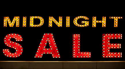 Midnight sale background. Brightly colored vintage advertising sign board with illumination