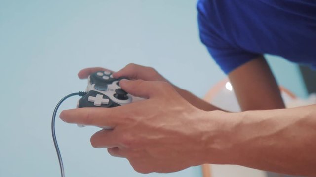 man concept playing gamepad hands video console on tv. Gamer play game with gamepad controller. Hand hold new joystick playing video console on lifestyle tv. Gaming man holding simulator joypad