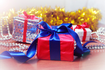 New Year's Christmas multicolored boxes with gifts and toys for the Christmas tree on a yellow shiny background