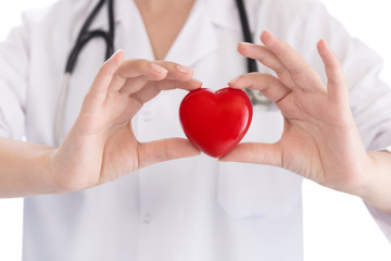 Medicine doctor holding red heart shape in hands on hospital background, medical concept