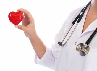 Medicine doctor holding red heart shape in hands on hospital background, medical concept