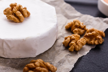 delicious creamy camembert cheese on a wooden rustic background