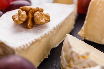 delicious creamy camembert cheese on a wooden rustic background