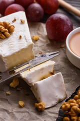 delicious creamy camembert cheese on a wooden rustic background