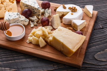 set of different cheeses on a wooden rustic background