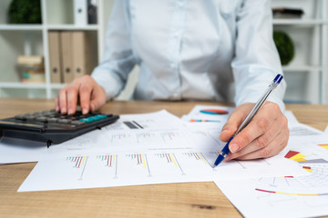 Cropped close up photo of lady in her formalwear she sit behind table with charts graph diagram in...