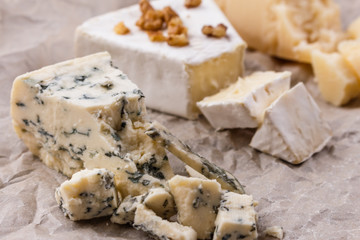 set of different cheeses on a wooden rustic background
