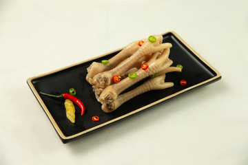 Chicken feet in old pot of vinegar