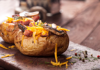 Baked stuffed potatoes with bacon, cheddar, mushrooms and dill