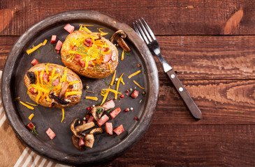 Baked stuffed potatoes with bacon, cheddar, mushrooms and dill