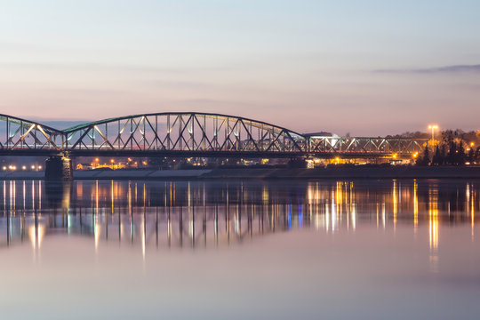 Fototapeta TORUN, POLAND - Joseph Pilsudski road bridge over the Vistula (Wisla) river at sunset.