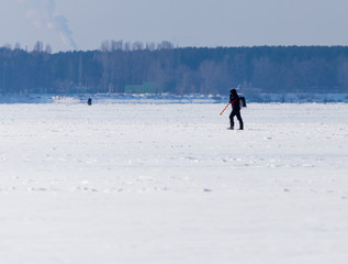 Man catches fish on ice in winter