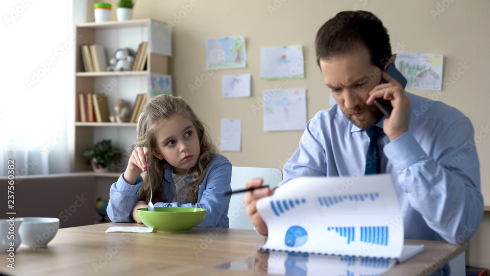 Wall mural Cute girl need parental attention, father ignoring daughter talking on phone