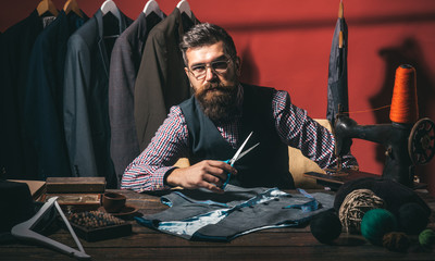 Talented tailor. business dress code. Handmade. suit store and fashion showroom. Bearded man tailor sewing jacket. sewing mechanization. retro and modern tailoring workshop. Beauty and fashion