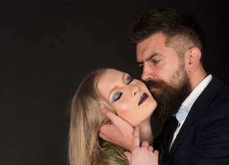 Sensual pleasures. Intimate couple in fashion clothing. Couple in love. Style icons. Bearded man hug woman with long hair. Fashion style and hair care. They both love fashion, copy space